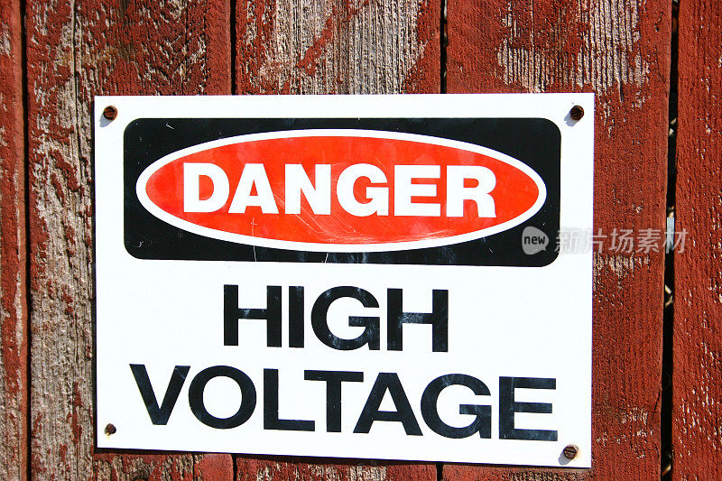危险。高电压标志风化木栅栏。