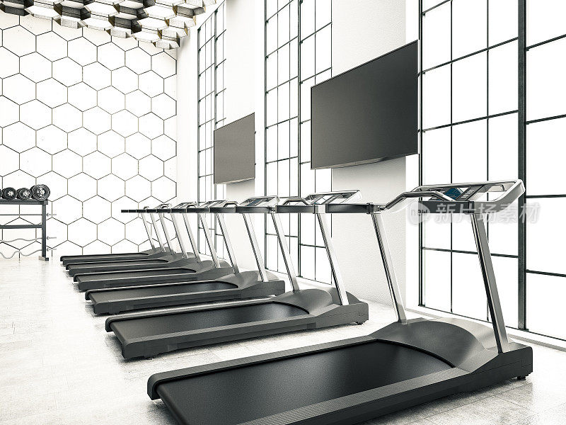 现代化的健身房室内配备跑步机和电视