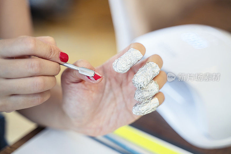 用金属箔去除手指上的指甲油，破坏指甲