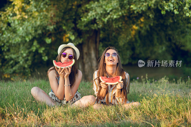 两个女人在外面吃西瓜