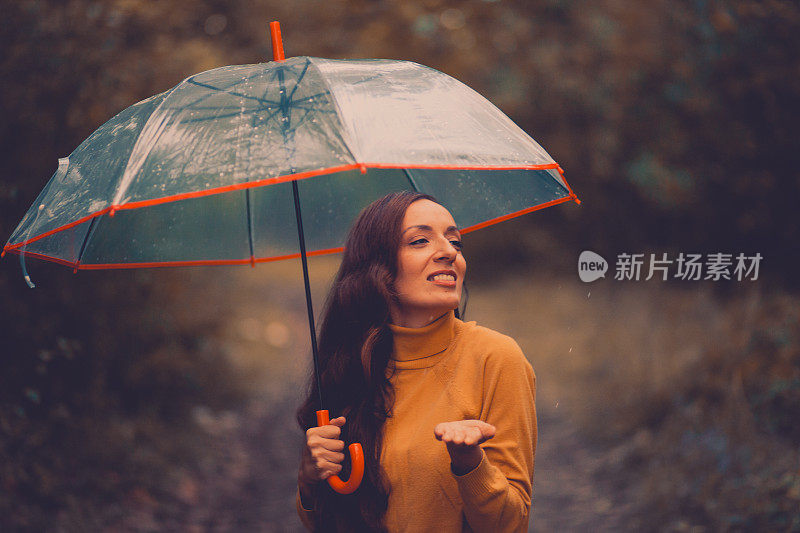 美丽的年轻女子享受着雨天