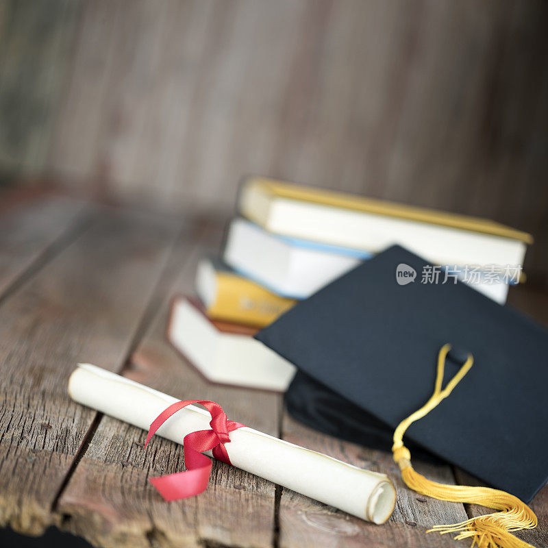 毕业2021帽和文凭概念上的木材背景