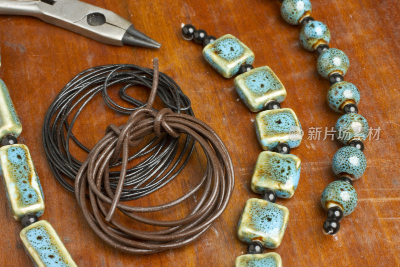 珠宝制作与珠子，皮绳和工具的特写