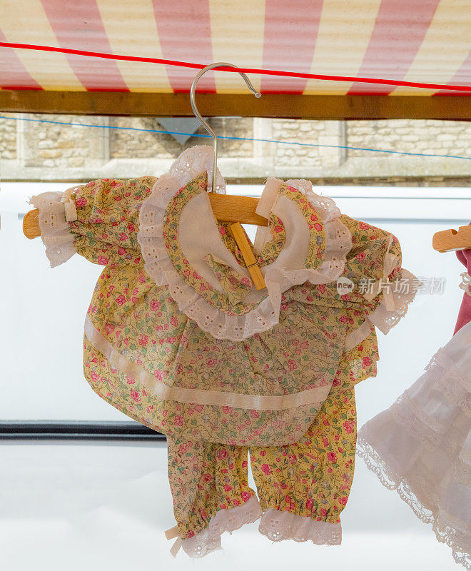 小女孩大小丑布娃娃服装在跳蚤市场的摊位上