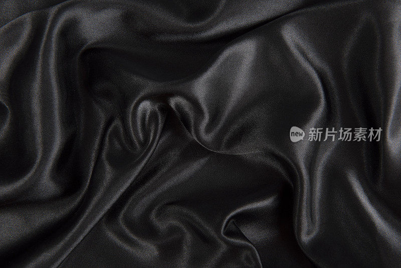 光滑优雅的黑色织物或液体波浪褶皱的垃圾真丝纹理缎天鹅绒材料