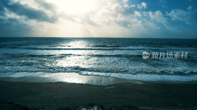 夕阳西下时，海浪翻滚在海滩上