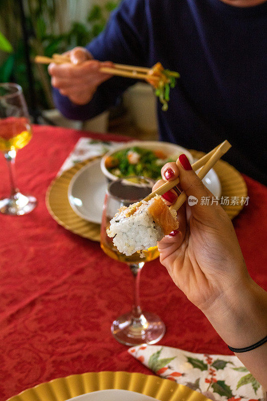 圣诞节用筷子在桌子上吃寿司