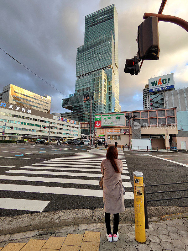 日本大阪，安野春光摩天大楼前的日本女孩