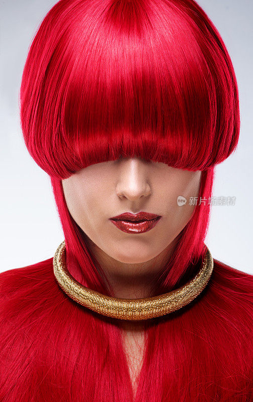 美丽的年轻女模特戴着红色假发在工作室拍摄