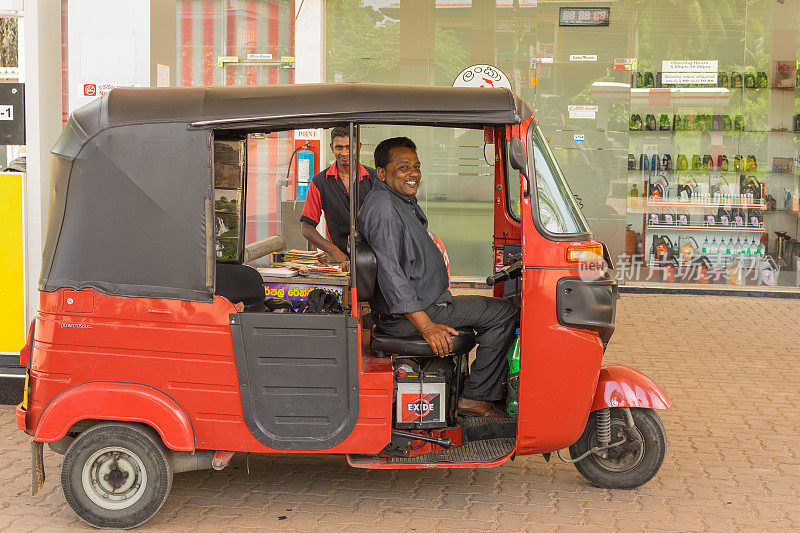 加油站的快乐的无名嘟嘟车司机。Tuktuk出租车是一种方便又便宜的交通工具。