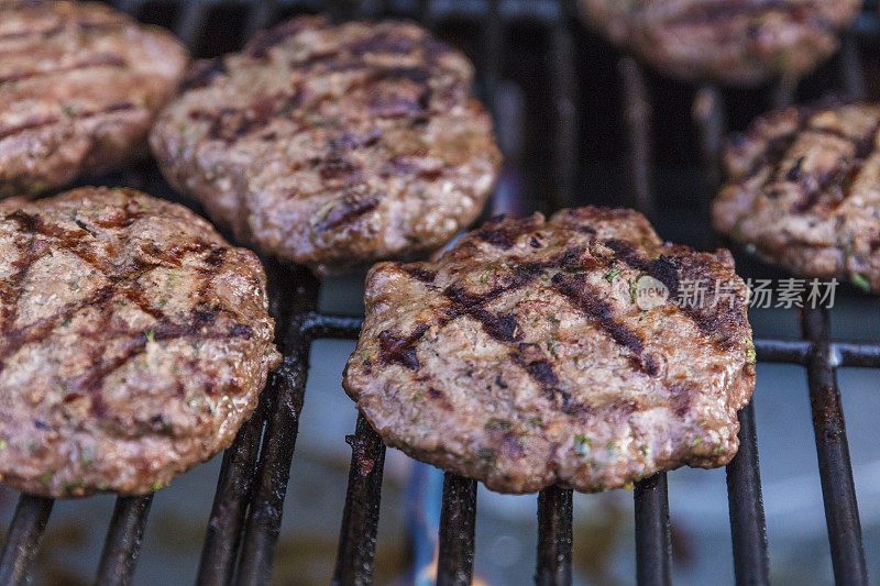 特写牛肉饼在木炭上烹饪汉堡包。