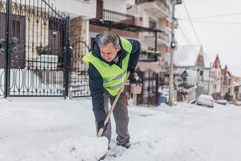 男子清扫积雪的门口