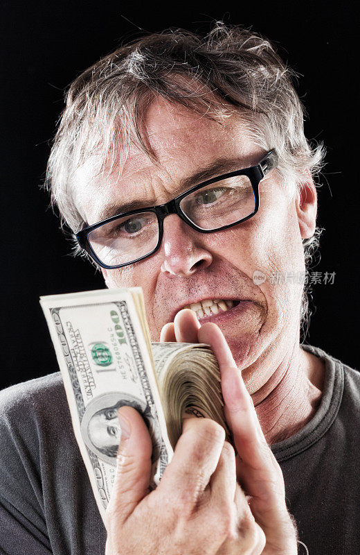 一个愤怒的成年人正在数一捆100美元的钞票