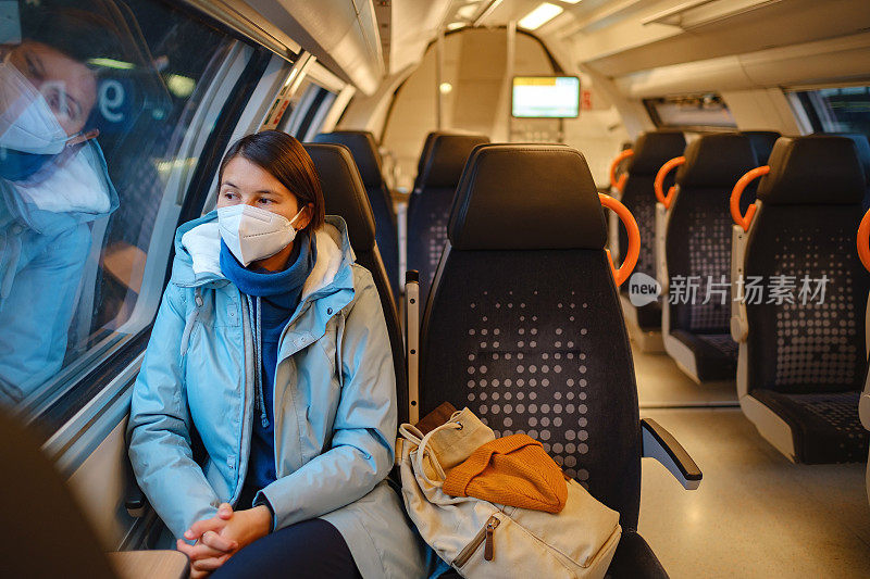 一个亚洲女人在冬天从火车窗外望出去