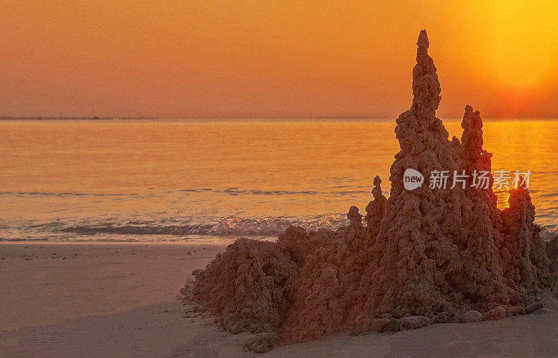 日落时海滩上的蚂蚁山