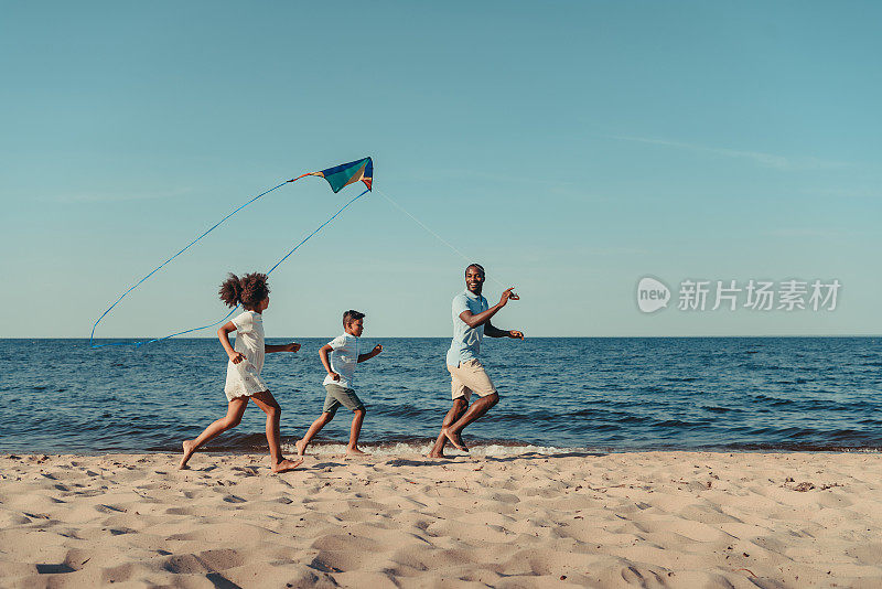爸爸和孩子们在海滩上玩风筝