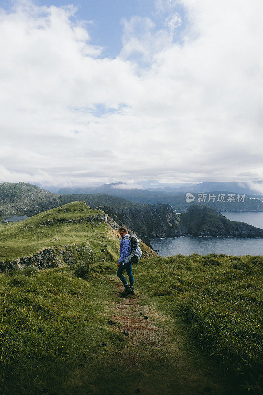 在挪威的Runde岛背包徒步旅行的女人