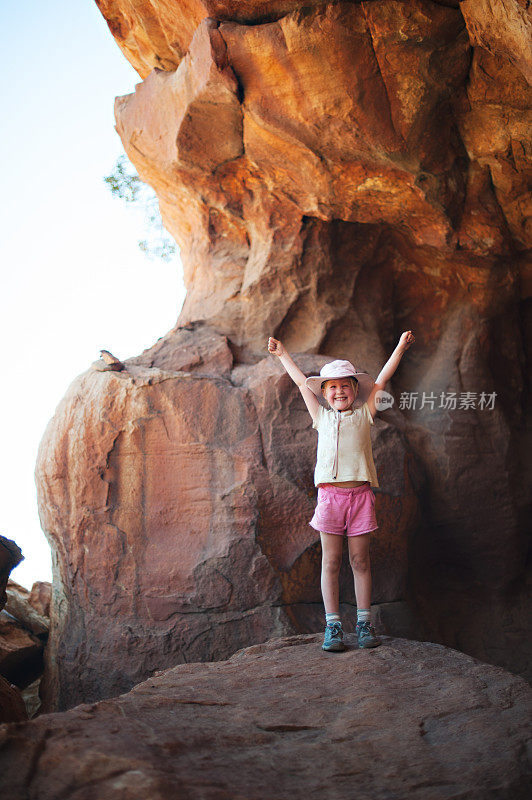 洞穴里美丽年轻的金发女孩成功地举起了手臂