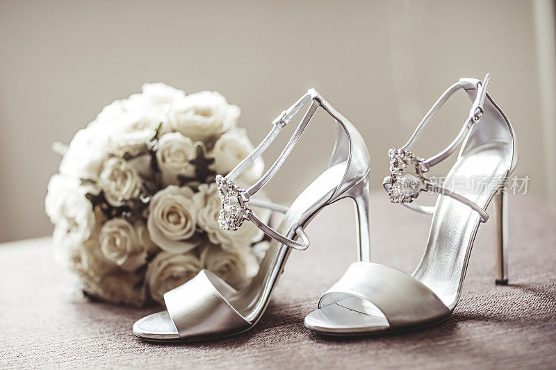 白色女性高跟鞋和婚礼花束的安排
