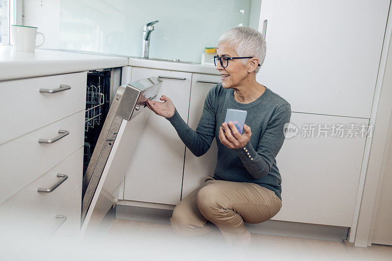 学着调整新洗碗机的成熟女人