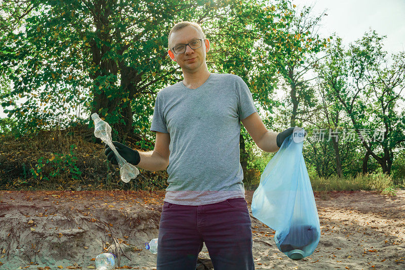 志愿者在垃圾袋里收集垃圾。Trash-free星球概念