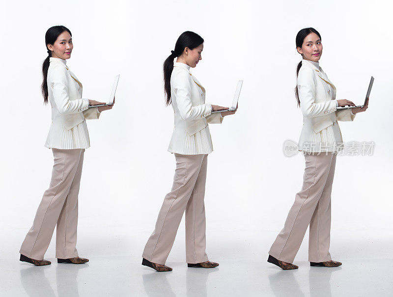 全长20年代亚洲女性穿正式的商务西装西装裤鞋。黑色长直发女性拿着笔记本电脑工作自信，向前走左转右，白色背景孤立
