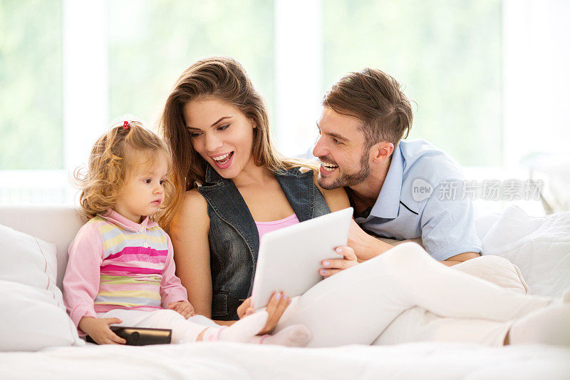 年轻的家庭使用数字平板电脑。