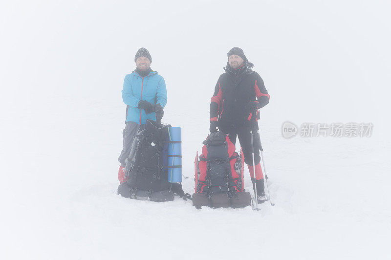 两个朋友在冬天雾蒙蒙的山上