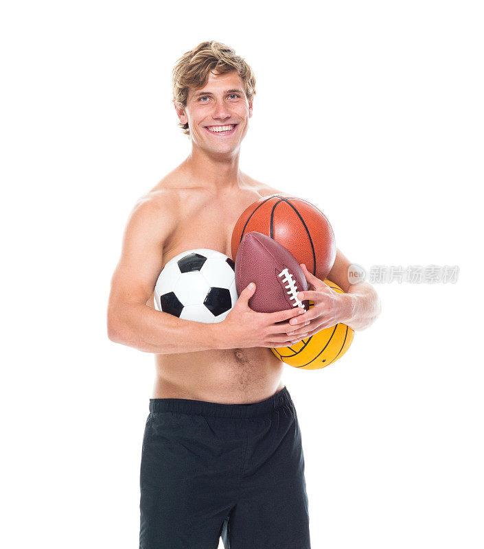迷人的赤膊男子在运动服装持有运动球
