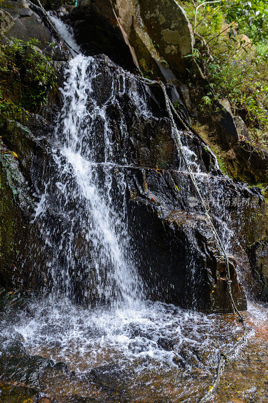 美丽的瀑布，急流和山涧在热带森林里，三亚市Yanoda公园。海南,中国。