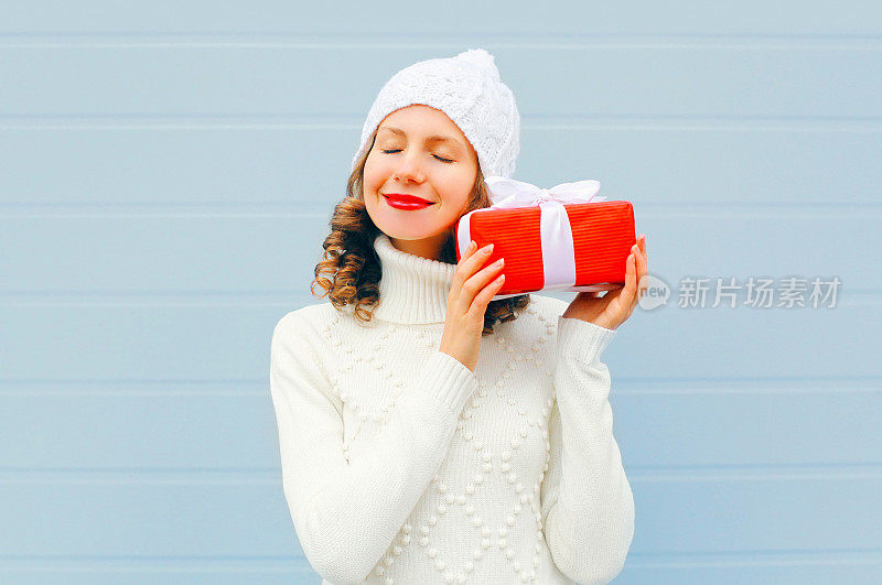 圣诞快乐微笑的年轻女子与礼物盒