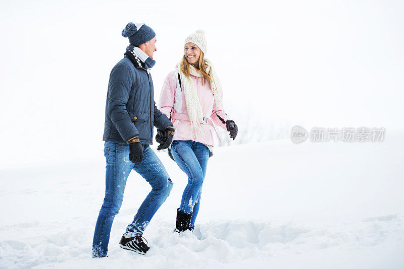 一对美丽的夫妇在冬天散步。