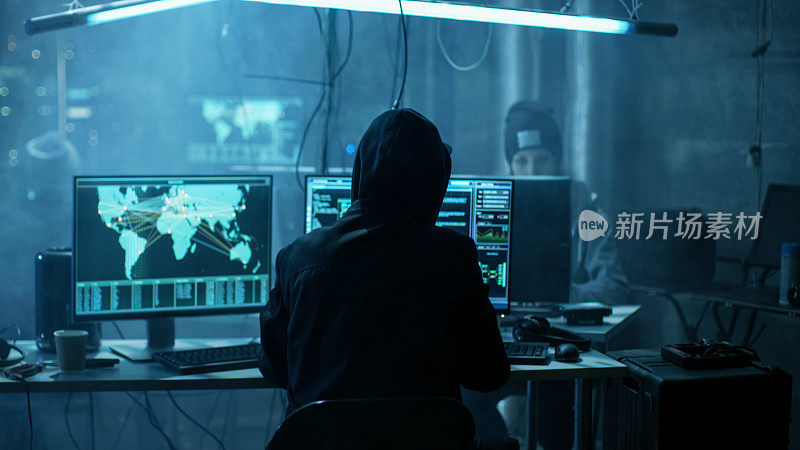 国际通缉青少年黑客团队用勒索软件感染服务器和基础设施。他们的藏身处是黑暗的，霓虹照明和有多个显示。