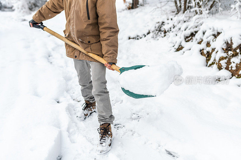 拿着雪铲的男人