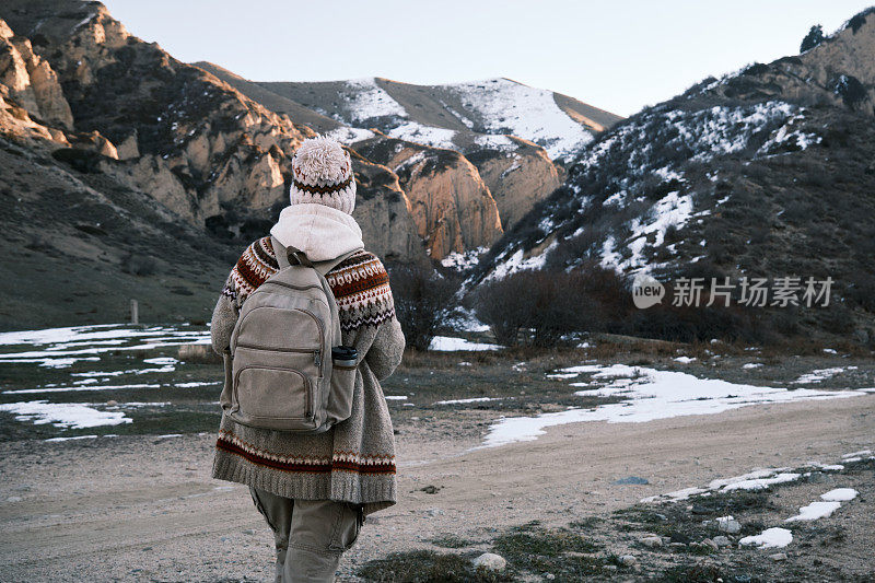 成熟的女游客正在冬天的山上徒步旅行