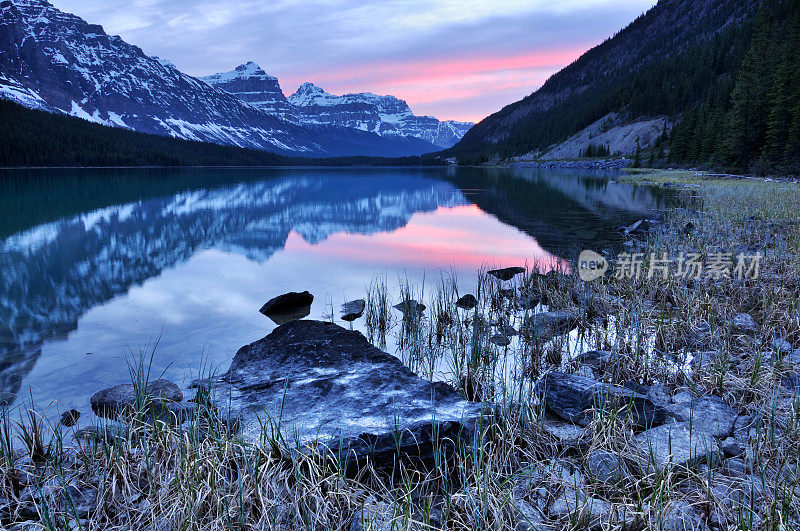在加拿大落基山脉的水鸟湖中倒影的黄昏山景