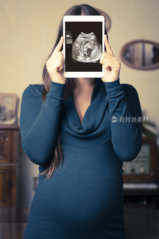 孕妇在平板电脑上工作