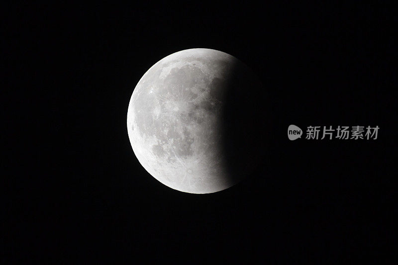超级血月，月全食的最后一个阶段在黑色的天空背景下，月球表面的三分之一被地球的阴影覆盖