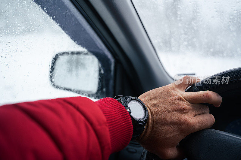 司机的POV驾驶在积雪覆盖的道路上，被困在了第一个下雪的道路上。冬季暴风雪天气耽搁了。山里有暴风雪。