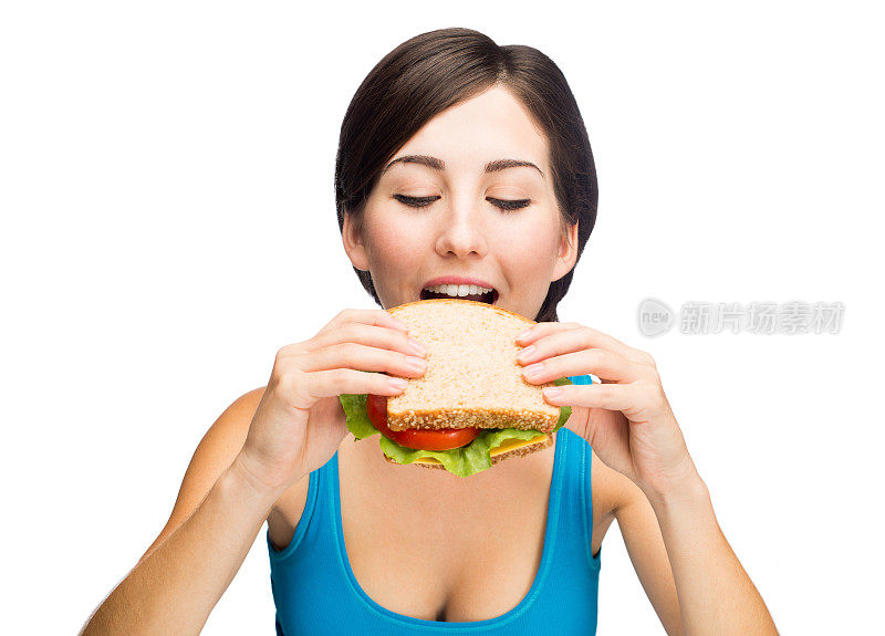 年轻漂亮的女人在吃三明治