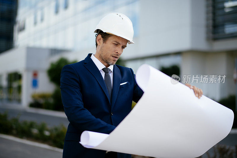 年轻的男工程师在一个建筑工地库存照片