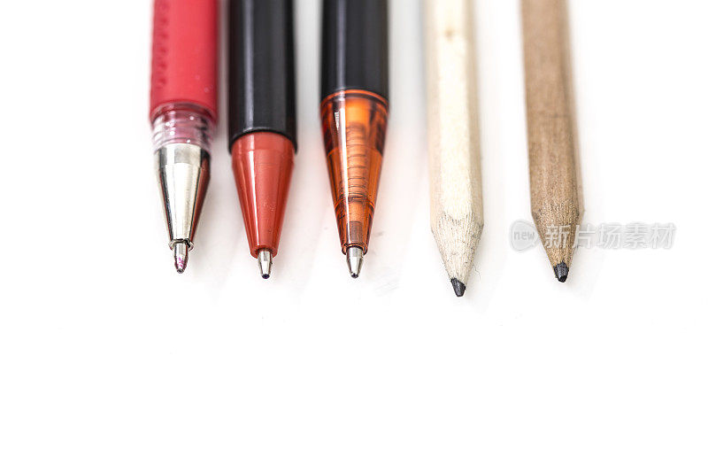许多钢笔和铅笔在白色背景上画得更近了