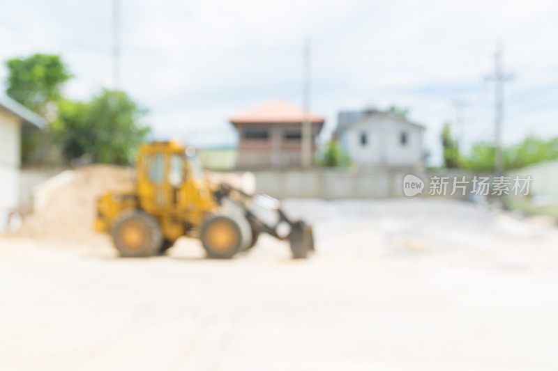 摘要模糊背景黄色液压拖拉机装载机或挖土机在建筑工地工作