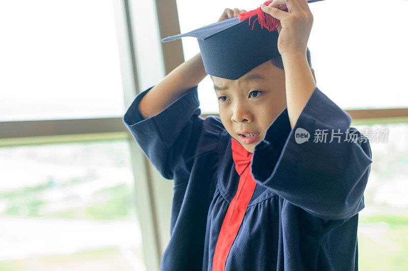 穿着毕业礼服的亚洲男孩