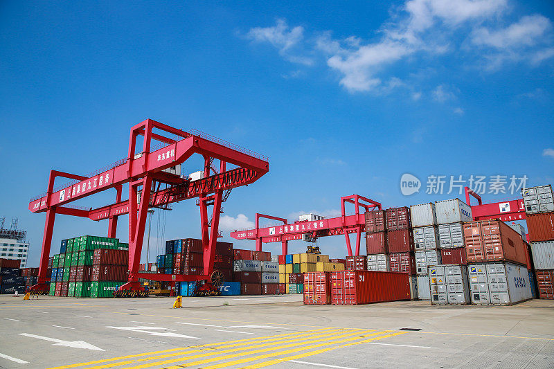 在苏州工业园区九江港外贸码头，工人们操作自动化起重机装卸集装箱。