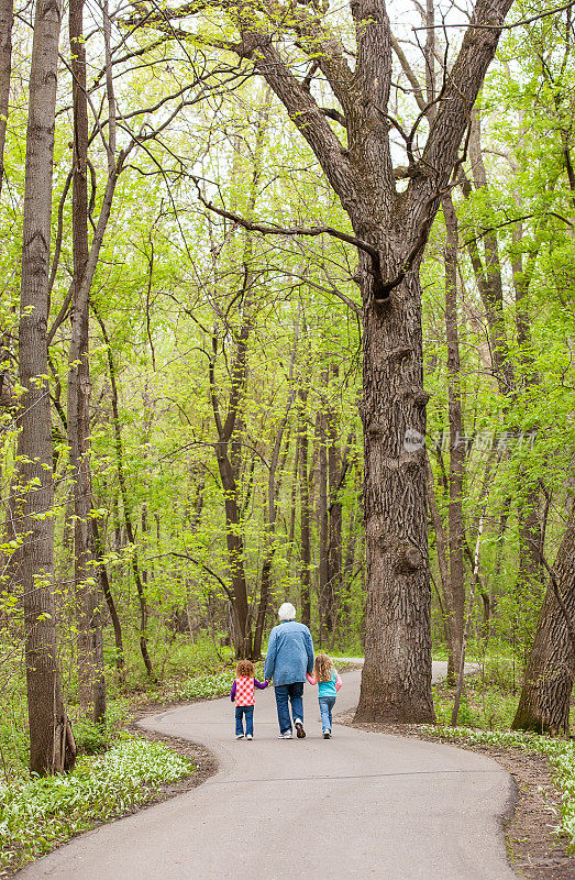 女孩和奶奶在树林里散步