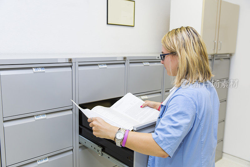 护士正在检查文件柜里病人的卡片索引
