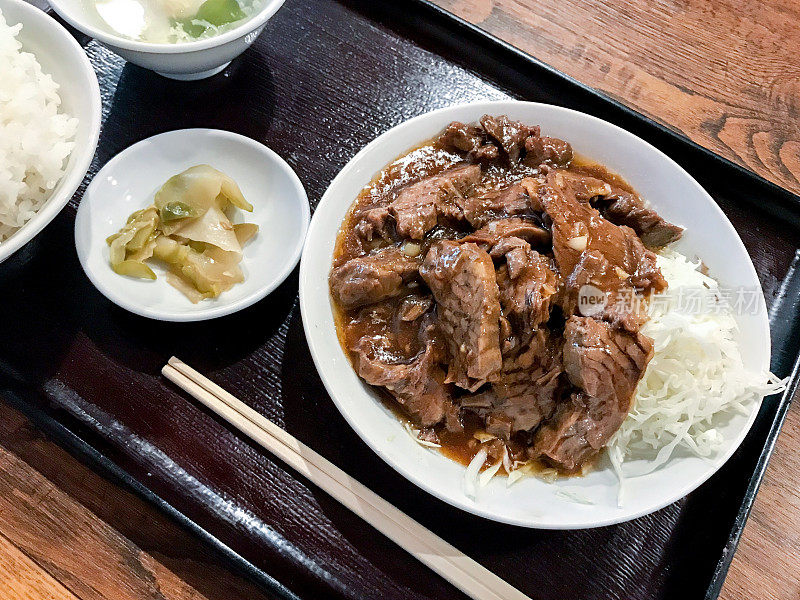 红烧牛肉午餐用托盘盛在桌上