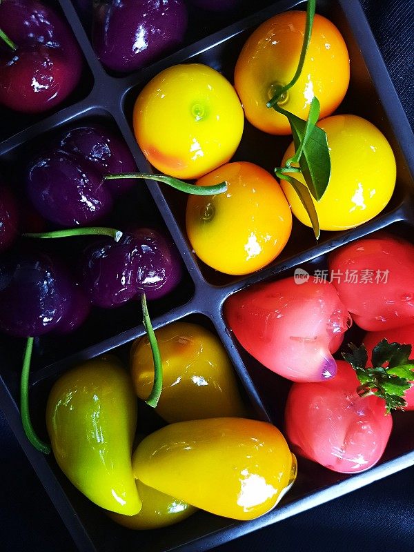 水果形状的绿豆小吃(泰国甜点)-黑色背景。