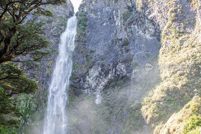 魔鬼潘趣碗瀑布在郁郁葱葱的新西兰绿色植物中瀑布，亚瑟山口的宝石